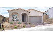 Charming single-story home featuring a welcoming front porch, desert landscaping, and a two-car garage at 11701 Hatchling Ave, Las Vegas, NV 89138