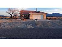 Charming single-story home with a well-maintained yard and two-car garage at 1900 E Highland Ave, Pahrump, NV 89048