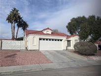 Charming single-story home featuring a red tile roof, desert landscaping, and an attached two-car garage at 4225 Bola Dr, North Las Vegas, NV 89032