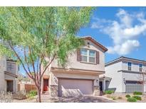 Inviting two-story home with a charming facade, complemented by a well-maintained front yard and mature tree at 6945 Trevelez St, Las Vegas, NV 89149