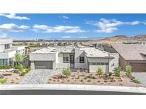 Modern single-story home with stone accents, desert landscaping, and a two-car garage at 818 Calluna St, Las Vegas, NV 89138