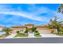 Beautiful single-story stucco home with a three-car garage, tile roof and well-manicured front yard at 11593 Glowing Sunset Ln, Las Vegas, NV 89135
