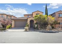 Inviting two-story home with a tile roof, a two car garage and desert landscaping at 12125 Las Hurdes Ave, Las Vegas, NV 89138