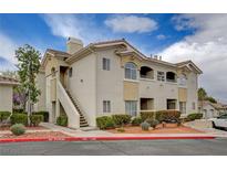 Attractive condo featuring two-story design, well-maintained landscaping, and a welcoming entrance at 1401 Red Crest Ln # 201, Las Vegas, NV 89144