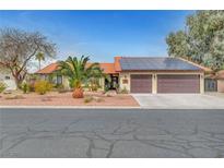 Charming single-story home featuring a two-car garage, solar panels, desert landscaping, and a red tile roof at 1580 Rosita Dr, Las Vegas, NV 89123
