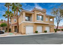 Charming three-story condo features a balcony, three garages, and well-maintained landscaping with palm trees at 251 S Green Valley Pkwy # 4611, Henderson, NV 89012