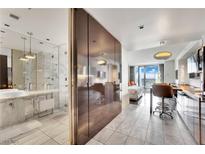 Contemporary condo featuring a marble bathroom, modern kitchen, and a comfortable bedroom with city views at 4381 W Flamingo Rd # 1903, Las Vegas, NV 89103
