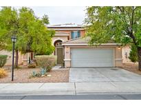Inviting two-story home with desert landscaping, covered porch, and a convenient two-car garage at 4917 Soaring Springs Ave, Las Vegas, NV 89131