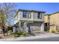 Charming two-story home with a modern stucco exterior and an attached two-car garage at 909 Cirrus Cloud Ave, Las Vegas, NV 89138