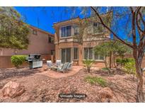 Relaxing backyard with patio furniture, grill, and desert landscaping at 11178 Corsica Mist Ave, Las Vegas, NV 89135