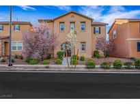 Charming two-story home with a well-manicured lawn and beautiful flowering trees at 3189 Sisley Garden Ave, Henderson, NV 89044