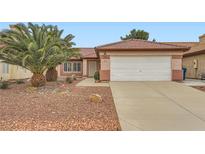 Charming single-story home featuring a well-maintained front yard and a two-car garage with a red tile roof at 3831 Flickering Star Dr, Las Vegas, NV 89103
