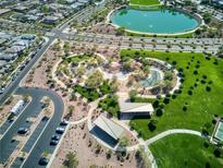 Beautiful aerial view showcases the community park with a lake and walking paths at 425 Canary Song Dr, Henderson, NV 89011