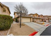 Charming two-story home featuring a tan exterior, a two-car garage, and a low-maintenance landscaped front yard at 544 Aspen Leaf St, Las Vegas, NV 89144