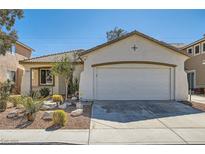 Charming single-story home with a two car garage and desert landscaping at 669 Elliot Peak Ave, Las Vegas, NV 89183