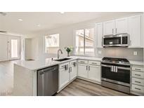 Modern kitchen featuring white cabinets, stainless steel appliances, and quartz countertops at 669 Elliot Peak Ave, Las Vegas, NV 89183