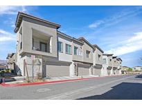 Charming townhome featuring a private balcony and attached one-car garage along a city street at 7304 N Decatur Blvd # 6, North Las Vegas, NV 89131