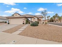 Charming single-story home with desert landscaping and a two-car garage, offering curb appeal at 845 Holly Lake Way, Henderson, NV 89002