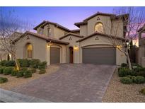 Elegant two-story home featuring a three-car garage and well-manicured landscaping at 12125 Edgehurst Ct, Las Vegas, NV 89138