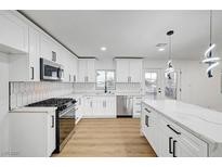Bright kitchen with stainless steel appliances, white cabinetry, and a modern backsplash at 2521 Richfield Blvd, Las Vegas, NV 89102