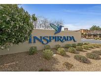 Inspirada community entrance sign with beautiful landscaping and view of building at 2785 Donatello Manor Pl, Henderson, NV 89044