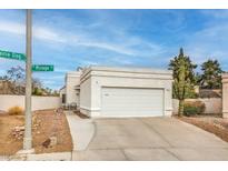 Home exterior featuring an attached two-car garage with a neutral color and a well-maintained desert landscape at 2812 Mirage Rd, Henderson, NV 89074