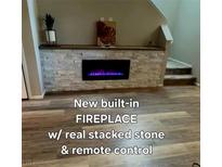 Modern fireplace with stacked stone and a dark mantel creates a focal point at 2844 Alenga St, Henderson, NV 89044