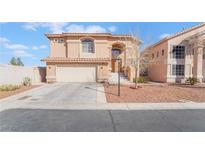 Inviting two-story home featuring a well-maintained front yard and attached two-car garage at 304 Jolly January Ave, Las Vegas, NV 89183