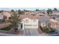 Charming two-story home featuring a three-car garage and desert landscaping at 810 Roaring Falls Ave, Henderson, NV 89052