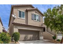 Charming two-story home with a well-manicured lawn and an attached two-car garage in a suburban neighborhood at 8248 Southern Cross Ave, Las Vegas, NV 89131