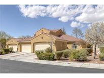 Charming home showcasing desert landscaping, a red tile roof, and multiple car garage on a sunny day at 8645 Deering Bay Dr, Las Vegas, NV 89131