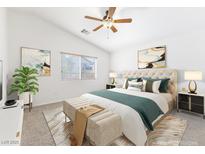 Bright main bedroom with a ceiling fan, large window, neutral carpet, and decoratively staged bed with bench seat at 10651 Streamside Ave, Las Vegas, NV 89129