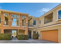 Lovely townhouse with a tandem garage and beautiful architecture details and professional landscaping at 10800 Amber Ridge Dr # 103, Las Vegas, NV 89144