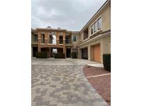 Attractive townhome showcasing a paved driveway leading to the garage, all set in a well-maintained community at 10800 Amber Ridge Dr # 103, Las Vegas, NV 89144