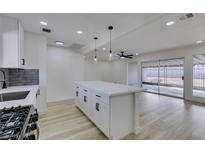 Bright kitchen featuring a large center island with white cabinets and a modern design at 1203 Tamerack Ave, Las Vegas, NV 89106