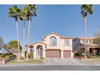 Beautiful two-story home featuring a well-manicured lawn and tall palm trees at 1252 Autumn Wind Way, Henderson, NV 89052