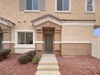 Charming townhouse featuring a neutral color scheme and inviting front porch at 1578 Ward Frontier Ln, Henderson, NV 89002