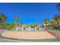 Beautiful home entrance with water fountain and palm trees on a clear day at 2050 W Warm Springs Rd # 4322, Henderson, NV 89014