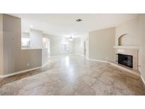 Open living space with tile flooring, fireplace, and archways to other rooms at 2050 W Warm Springs Rd # 4322, Henderson, NV 89014