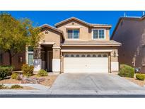 Charming two-story home with a two-car garage, manicured landscaping, and a welcoming front entrance at 304 Iron Summit Ave, North Las Vegas, NV 89031