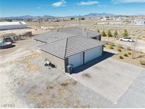 Expansive single-story home with neutral exterior, two-car garage and mature landscaping in desert setting at 3050 Oakridge Ave, Pahrump, NV 89048