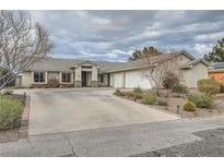 Attractive single-story home with a long driveway and a three-car garage providing ample parking space at 4350 Bossart Ct, Las Vegas, NV 89102