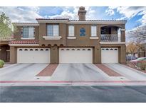 Charming multi-story townhome featuring multiple garage bays and a quaint balcony at 5465 Cardinal Ridge Ct # 103, Las Vegas, NV 89149