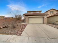 Charming home featuring a two-car garage, low-maintenance landscaping, and a cozy, inviting facade at 6228 Grace Mountain St, Las Vegas, NV 89115