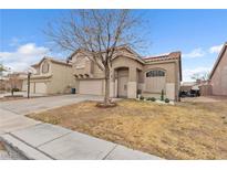 Charming two-story home with desert landscaping, neutral paint, a two car garage, and a concrete driveway at 6394 Wild Strawberry Ln, Las Vegas, NV 89142