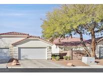 Charming single-story home features a two-car garage, tile roof, and mature landscaping at 7722 Top Hat Ave, Las Vegas, NV 89113