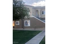 A two-story building features stucco walls, a staircase with metal railings, and a well-maintained landscape at 833 Aspen Peak Loop # 2522, Henderson, NV 89011