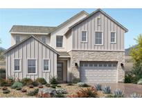 Beautiful two-story home with stone accents, a two-car garage, and professionally landscaped front yard at 8979 Rolling Pietra St, Las Vegas, NV 89166