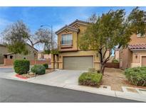 Two-story home with a two-car garage, low maintenance landscaping, and a well-kept front yard at 9180 Wine Cellar Ave, Las Vegas, NV 89148