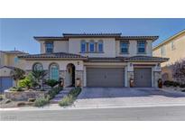 Charming two-story home featuring a tile roof, three-car garage, and manicured front landscaping at 12121 Cabo Rojo Ave, Las Vegas, NV 89138